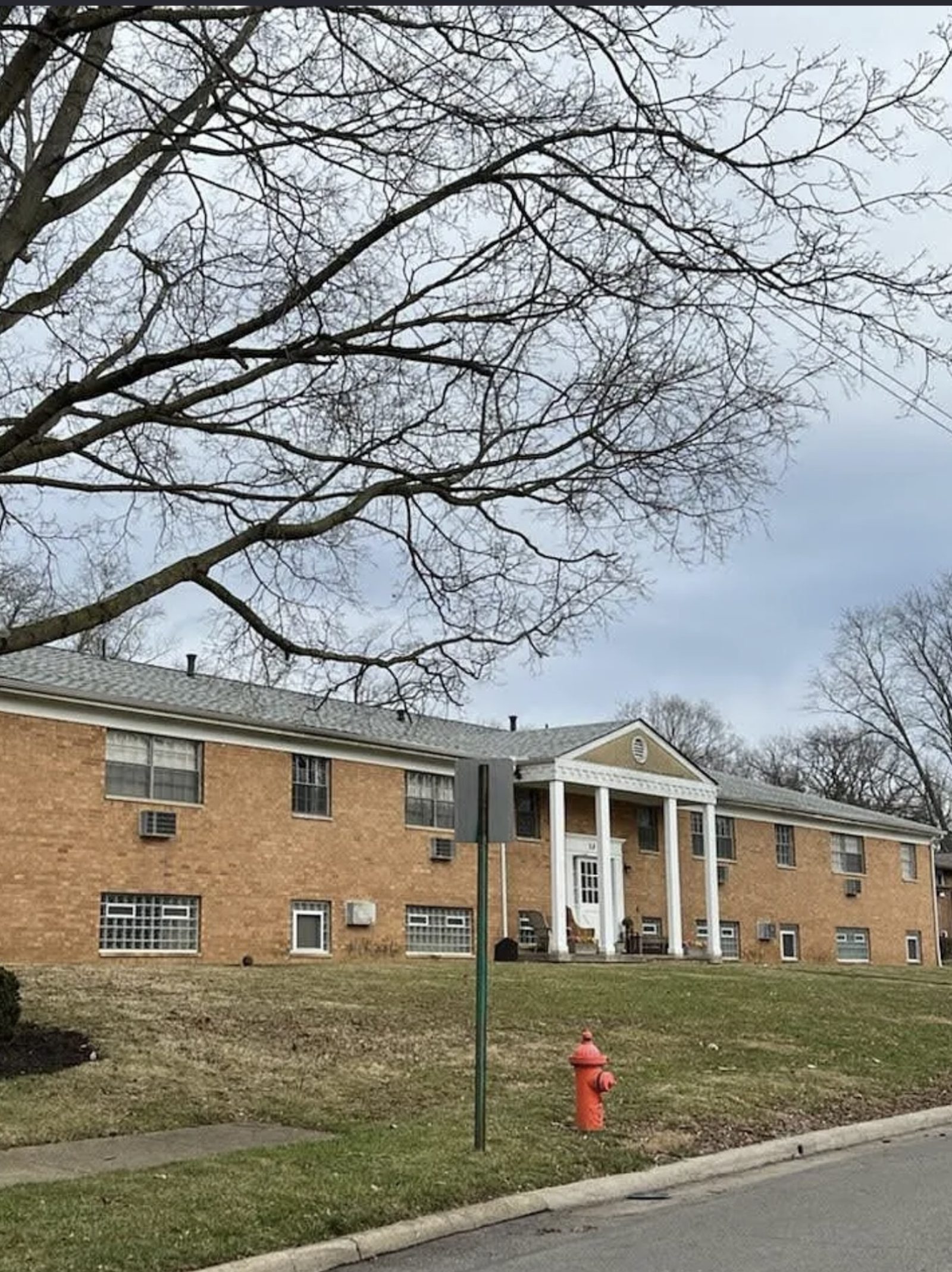 Before: brick apartment building entrance with white columns, Columbus OH