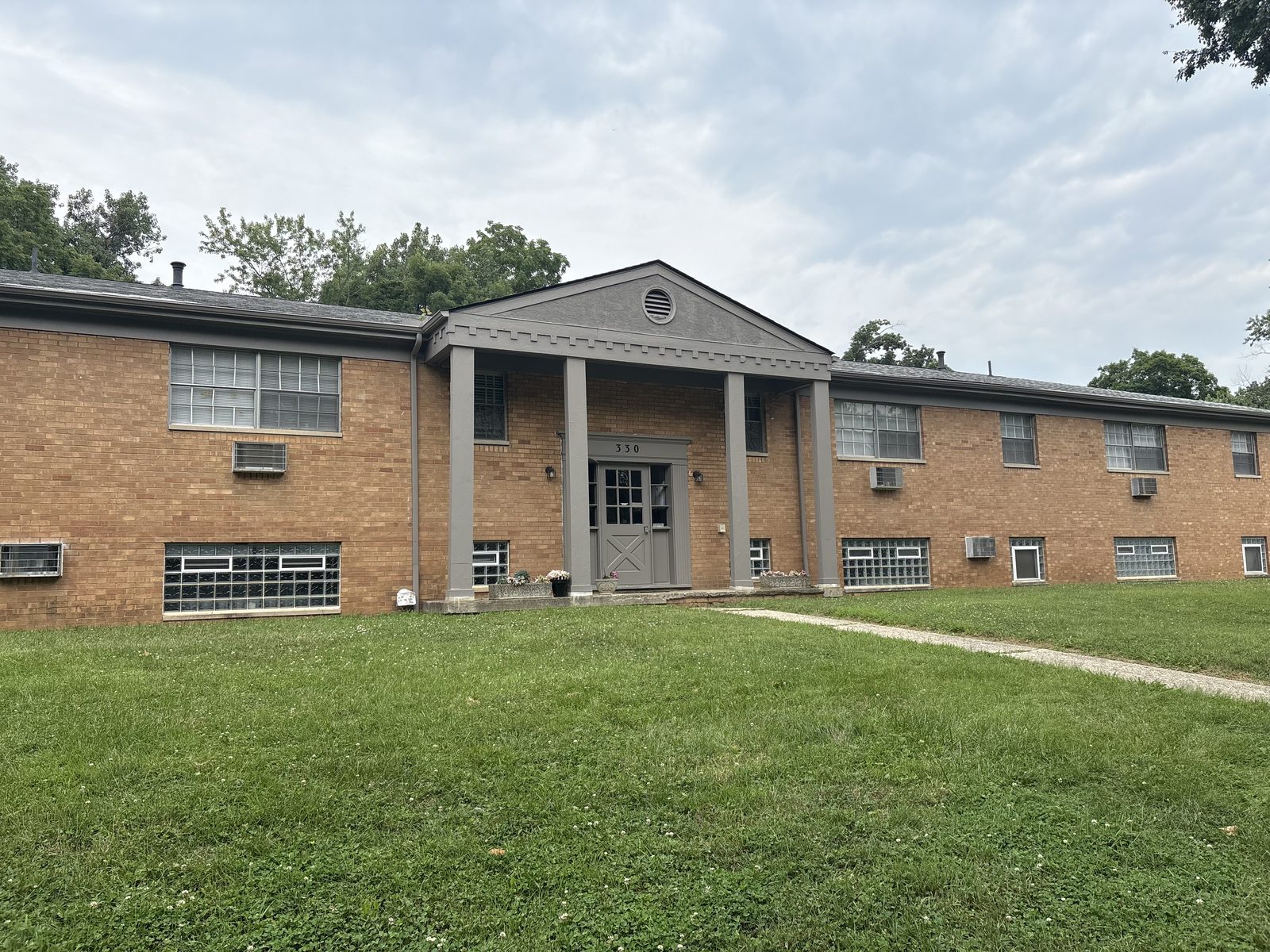 After: repainted apartment building entrance with gray columns and trim, Columbus OH